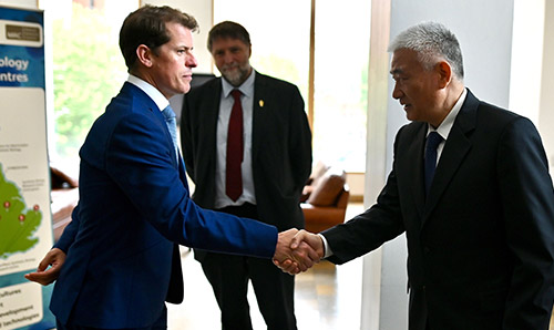 Neil Dixon shaking hands with a visitor
